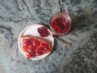 Description: strawberry jam on toast, jar of strawberry jam