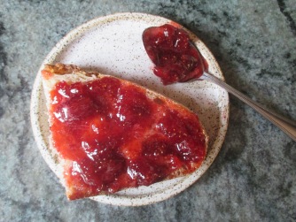 Description: strawberry jam on toast and spoon