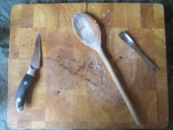 cutting board with spoons, knife