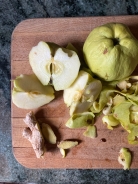 apples, ginger, and apple peels on cutting board