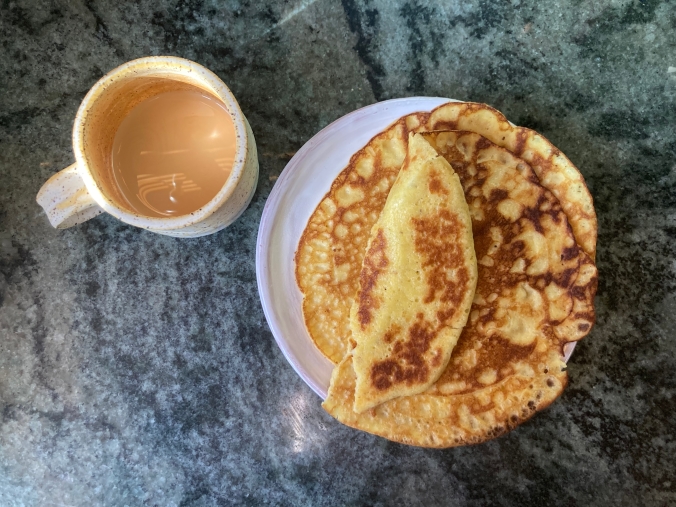 coffee in cup, pancake on plate